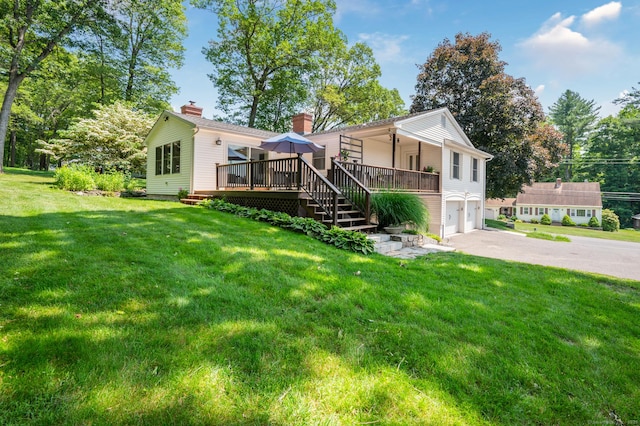 117 Woodfield Rd, Bristol, CT 06010 - view of front facade with an attached garage, a chimney, driveway, a deck, and a front lawn
