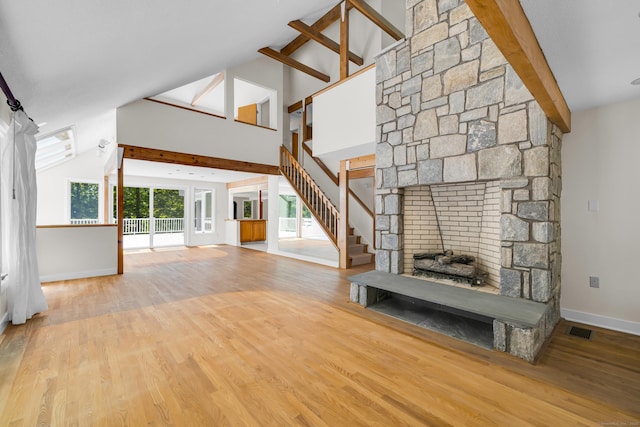 11 Island Bay Cir, Guilford, CT 06437 - unfurnished living room featuring wood finished floors, a stone fireplace, and stairs