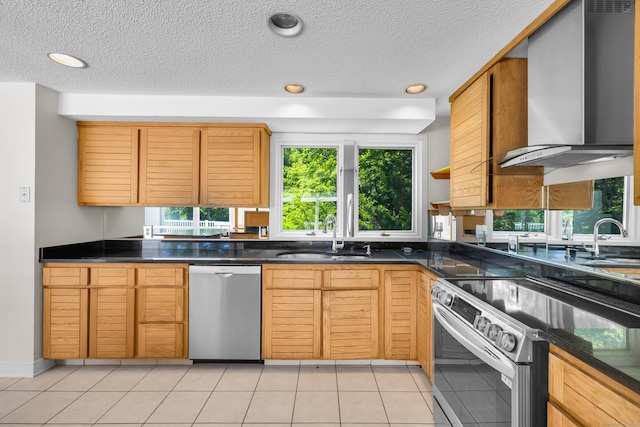 11 Island Bay Cir, Guilford, CT 06437 - kitchen with stainless steel appliances, wall chimney exhaust hood, plenty of natural light, dark countertops, and a textured ceiling