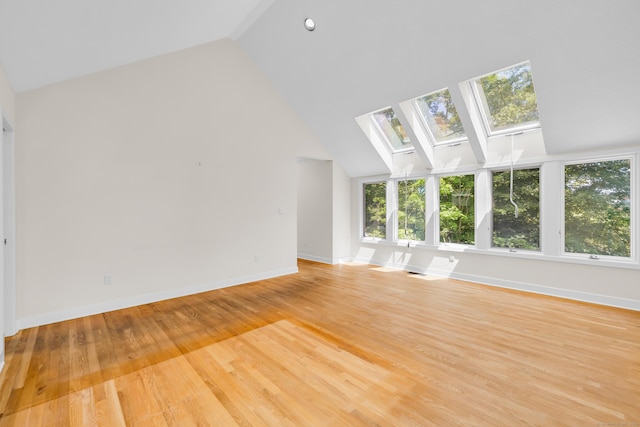 11 Island Bay Cir, Guilford, CT 06437 - unfurnished living room featuring a skylight, light wood finished floors, and high vaulted ceiling