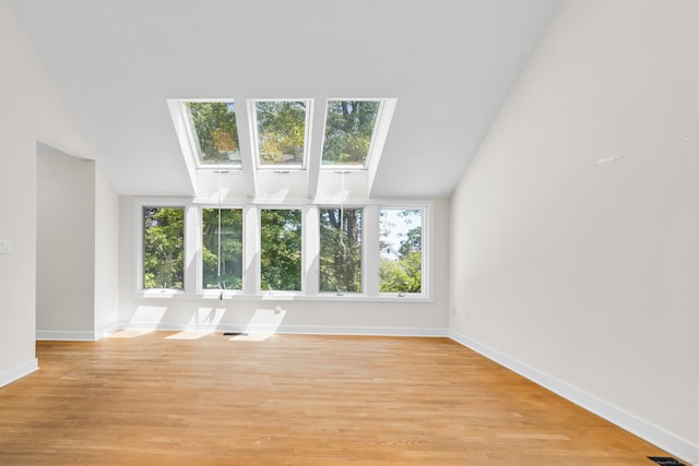 11 Island Bay Cir, Guilford, CT 06437 - unfurnished living room with vaulted ceiling, a skylight, and light wood-type flooring