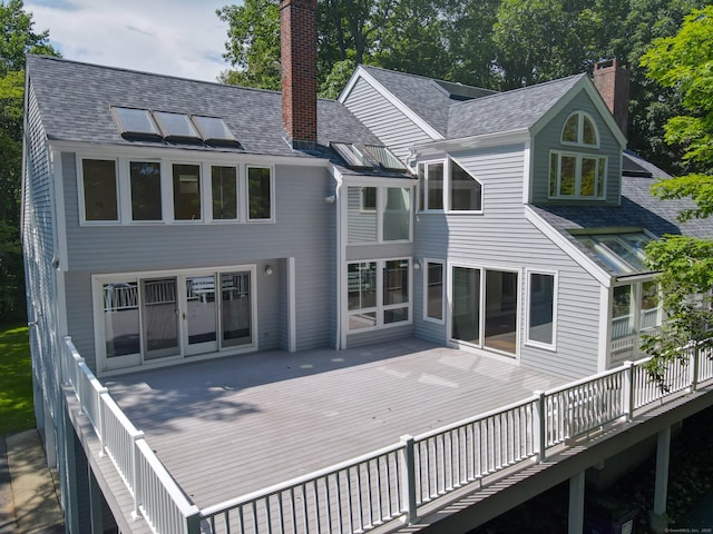 11 Island Bay Cir, Guilford, CT 06437 - back of house featuring a deck, a chimney, and a shingled roof