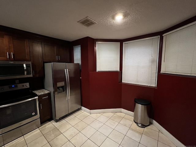 132 Maple Ave Unit B, Hartford, CT 06114 - kitchen featuring stainless steel appliances, dark brown cabinetry, and light tile patterned floors