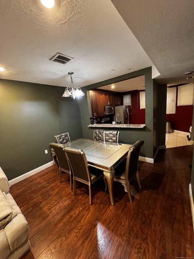 132 Maple Ave Unit B, Hartford, CT 06114 - dining room featuring a textured ceiling and wood finished floors