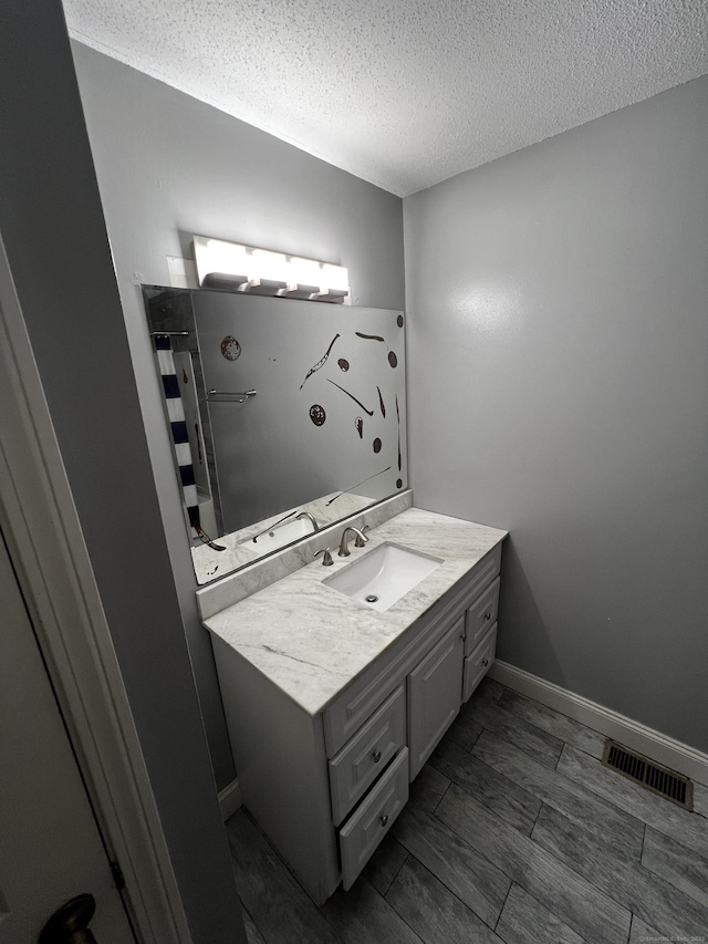 132 Maple Ave Unit B, Hartford, CT 06114 - full bath featuring vanity, a textured ceiling, and a shower with shower curtain