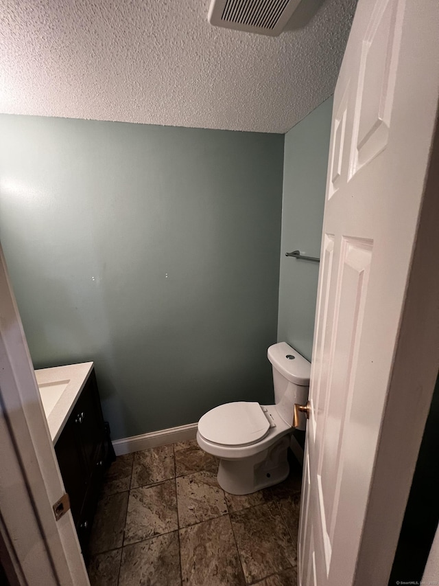 132 Maple Ave Unit B, Hartford, CT 06114 - half bathroom with vanity, a textured ceiling, and stone finish flooring