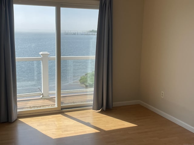 27 Bayview Pl Apt 5, West Haven, CT 06516 - empty room featuring a water view and wood finished floors