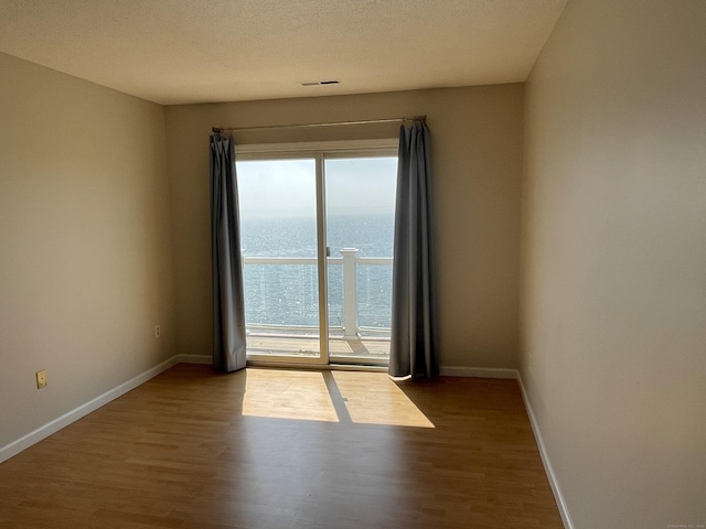 27 Bayview Pl Apt 5, West Haven, CT 06516 - empty room with wood finished floors and a water view