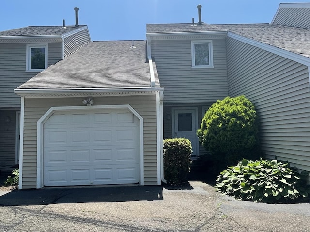 27 Bayview Pl Apt 5, West Haven, CT 06516 - rear view of house with a garage, a shingled roof, and driveway