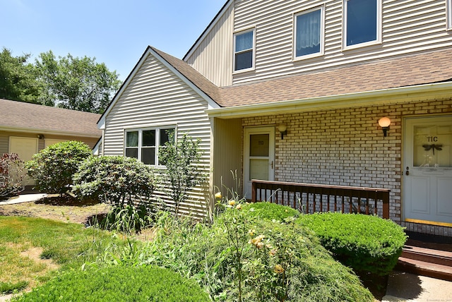 11 Thistle Way Apt D, East Windsor, CT 06016 - doorway to property with roof with shingles and brick siding