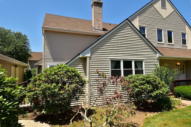 11 Thistle Way Apt D, East Windsor, CT 06016 - rear view of property featuring a chimney and a shingled roof