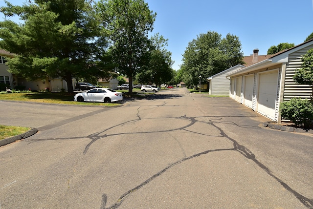 11 Thistle Way Apt D, East Windsor, CT 06016 - view of asphalt road with community garages and curbs