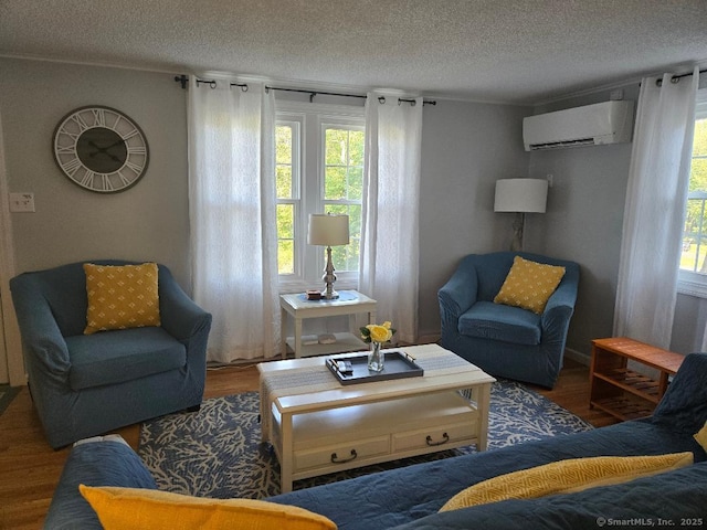 60 Spring Glen Rd, East Lyme, CT 06357 - living area with a wall mounted AC, wood finished floors, and a textured ceiling