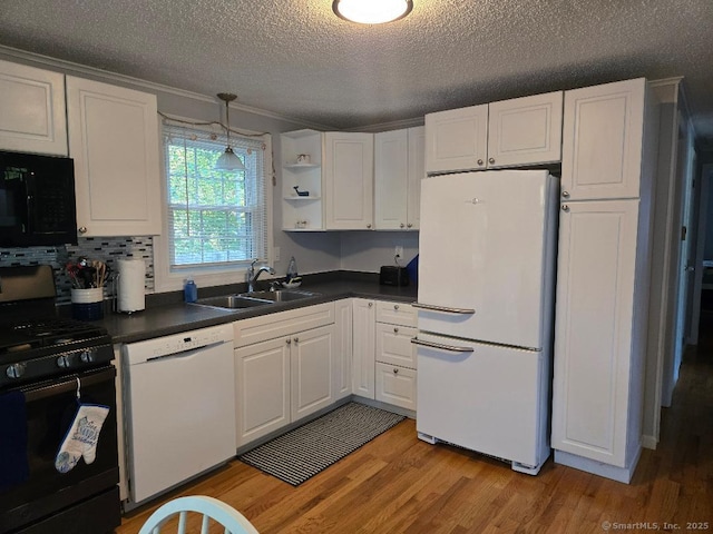 60 Spring Glen Rd, East Lyme, CT 06357 - kitchen featuring black appliances, dark countertops, light wood-style flooring, a textured ceiling, and white cabinetry