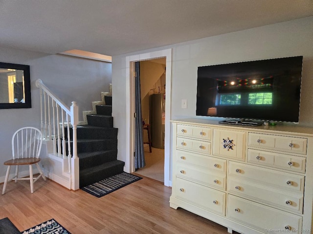 60 Spring Glen Rd, East Lyme, CT 06357 - living area with light wood-type flooring, stairs, and water heater