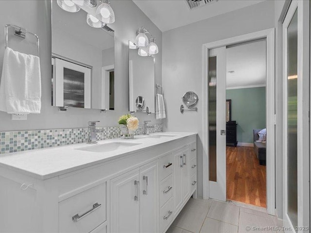 964 Red Fox Rd, Orange, CT 06477 - bathroom with double vanity, tile patterned floors, and decorative backsplash