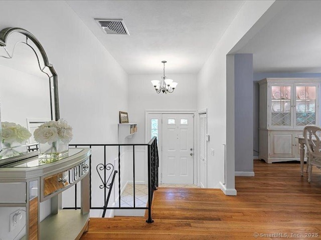 964 Red Fox Rd, Orange, CT 06477 - foyer entrance with a chandelier and wood finished floors