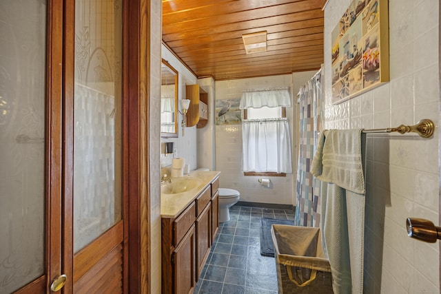 141 Peach Orchard Rd, Waterbury, CT 06706 - full bath with wood ceiling, vanity, tile walls, and tile patterned floors