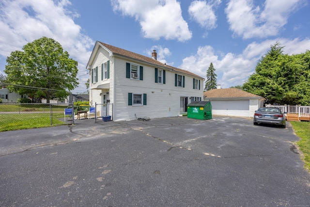 141 Peach Orchard Rd, Waterbury, CT 06706 - colonial house with a chimney, an outdoor structure, and a garage