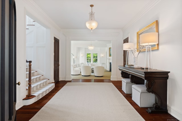 31 Contentment Island Rd, Darien, CT 06820 - foyer entrance featuring dark wood-type flooring, a chandelier, stairway, and ornamental molding