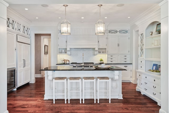 31 Contentment Island Rd, Darien, CT 06820 - kitchen with wine cooler, dark countertops, dark wood-style flooring, a breakfast bar, and crown molding