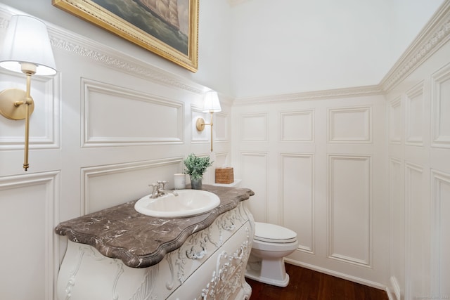 31 Contentment Island Rd, Darien, CT 06820 - half bath with a decorative wall, vanity, and wood finished floors