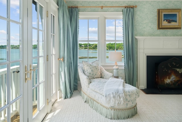 31 Contentment Island Rd, Darien, CT 06820 - living area featuring a water view, wallpapered walls, a fireplace with flush hearth, and french doors