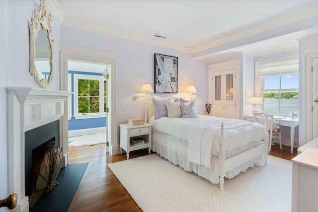 31 Contentment Island Rd, Darien, CT 06820 - bedroom featuring multiple windows, crown molding, wood finished floors, and a fireplace