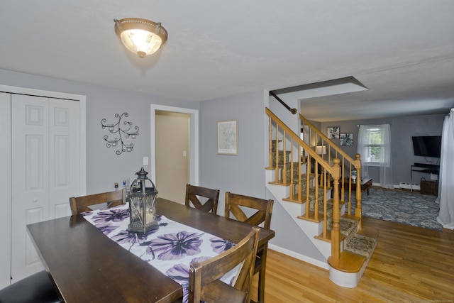 33 Old King St, Enfield, CT 06082 - dining space with wood finished floors, stairway, and a baseboard heating unit