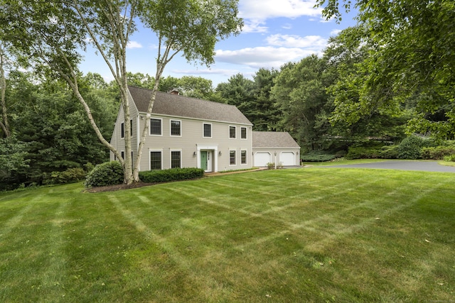 2 Applewood Cmn, East Lyme, CT 06333 - colonial inspired home featuring an attached garage, a front yard, a chimney, asphalt driveway, and a shingled roof