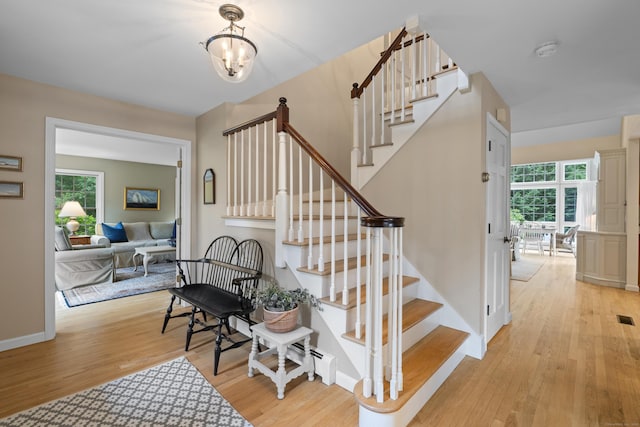 2 Applewood Cmn, East Lyme, CT 06333 - stairway with wood finished floors, plenty of natural light, and a chandelier