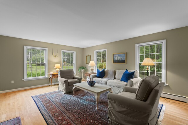 2 Applewood Cmn, East Lyme, CT 06333 - living area with a baseboard heating unit and light wood-style floors