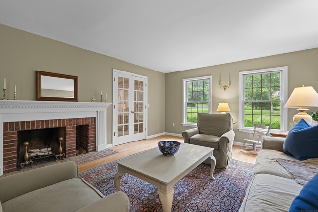 2 Applewood Cmn, East Lyme, CT 06333 - living area with wood finished floors, french doors, and a fireplace