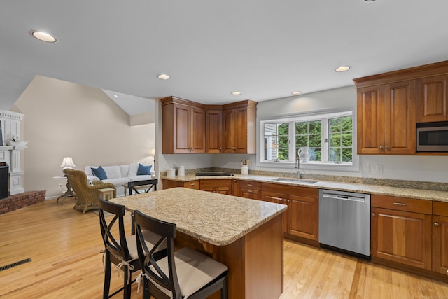 2 Applewood Cmn, East Lyme, CT 06333 - kitchen featuring stainless steel appliances, light wood-style flooring, a breakfast bar, light stone countertops, and recessed lighting