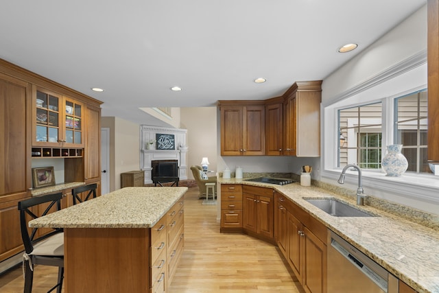 2 Applewood Cmn, East Lyme, CT 06333 - kitchen with dishwasher, light wood-type flooring, a fireplace, a kitchen bar, and recessed lighting