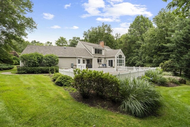 2 Applewood Cmn, East Lyme, CT 06333 - rear view of property with a lawn, a chimney, and a wooden deck