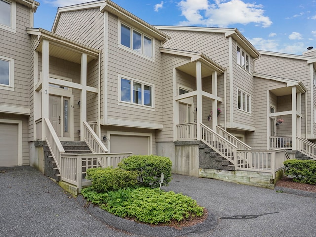 11 Boulevard Dr Unit 10-44, Danbury, CT 06810 - view of building exterior with stairway, asphalt driveway, and a garage