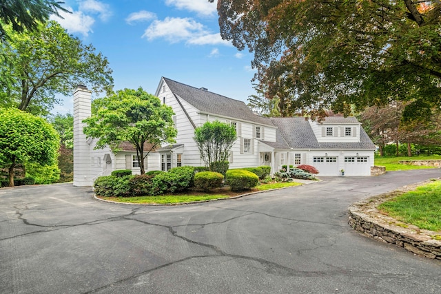 39 Campbell Rd, Fairfield, CT 06824 - view of front of property featuring a chimney, asphalt driveway, and a garage
