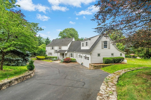 39 Campbell Rd, Fairfield, CT 06824 - view of front of home with asphalt driveway, roof with shingles, and a front lawn