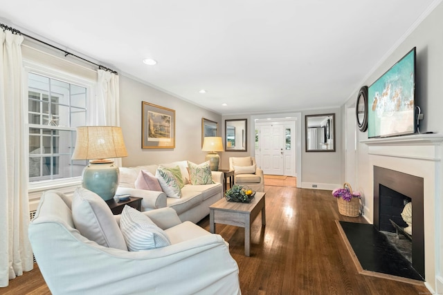 39 Campbell Rd, Fairfield, CT 06824 - living area with ornamental molding, a fireplace with flush hearth, wood finished floors, and recessed lighting