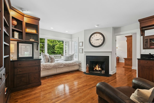 39 Campbell Rd, Fairfield, CT 06824 - living area with a fireplace with flush hearth, wood finished floors, and recessed lighting