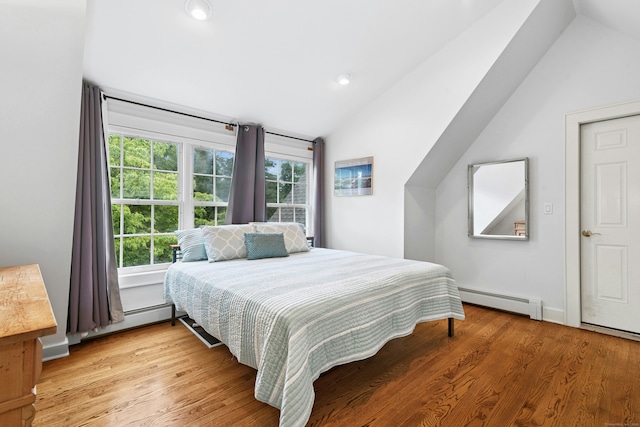 39 Campbell Rd, Fairfield, CT 06824 - bedroom with a baseboard heating unit, vaulted ceiling, and light wood finished floors