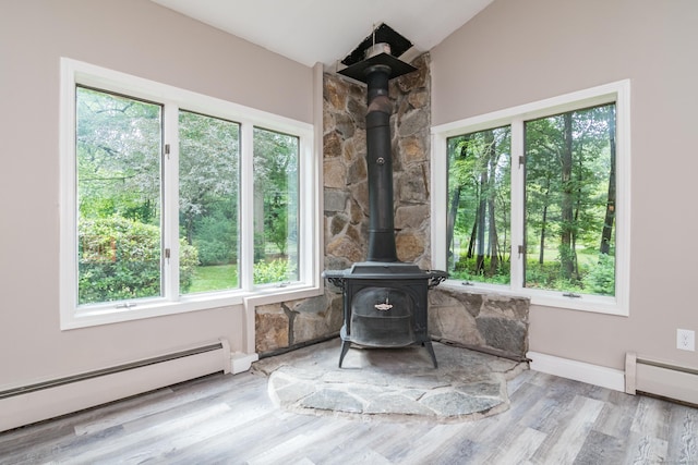 63 Rose Haven Rd, Somers, CT 06071 - living area with a baseboard heating unit, a wood stove, wood finished floors, lofted ceiling, and a baseboard radiator