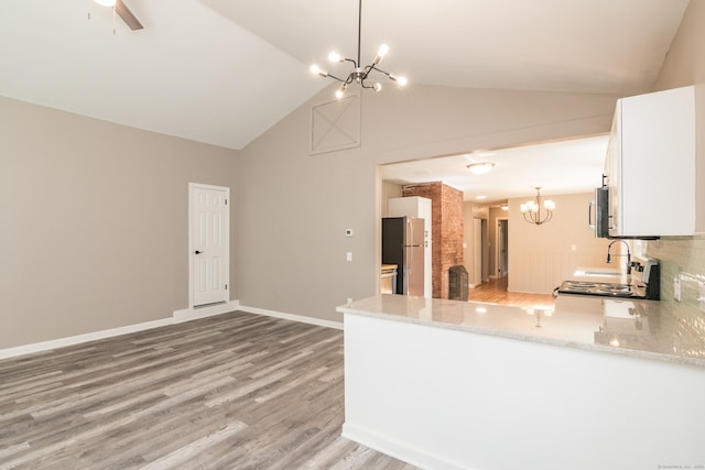 63 Rose Haven Rd, Somers, CT 06071 - kitchen with a chandelier, appliances with stainless steel finishes, light stone counters, light wood-style floors, and white cabinets