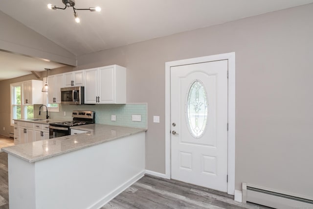 63 Rose Haven Rd, Somers, CT 06071 - kitchen with stainless steel appliances, a baseboard radiator, light wood-style flooring, backsplash, and white cabinetry