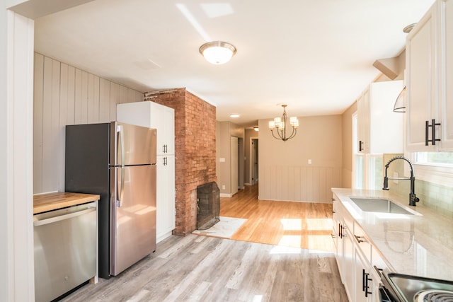 63 Rose Haven Rd, Somers, CT 06071 - kitchen featuring stainless steel appliances, light wood finished floors, a chandelier, white cabinetry, and light stone countertops