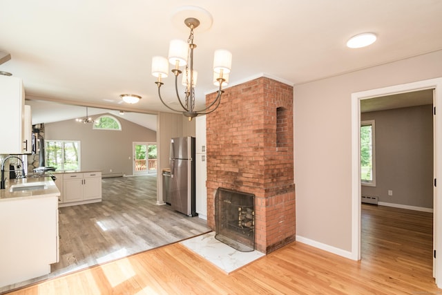 63 Rose Haven Rd, Somers, CT 06071 - kitchen featuring freestanding refrigerator, a chandelier, a baseboard heating unit, light wood finished floors, and white cabinets