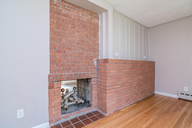 63 Rose Haven Rd, Somers, CT 06071 - detailed view of wood finished floors, a brick fireplace, and a baseboard heating unit