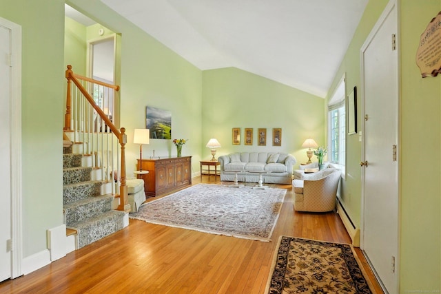 41 White Birch Dr, Trumbull, CT 06611 - living room featuring wood finished floors, a baseboard radiator, stairway, and high vaulted ceiling