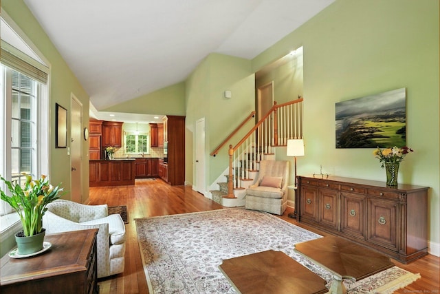 41 White Birch Dr, Trumbull, CT 06611 - living room featuring light wood-style floors, vaulted ceiling, and stairway
